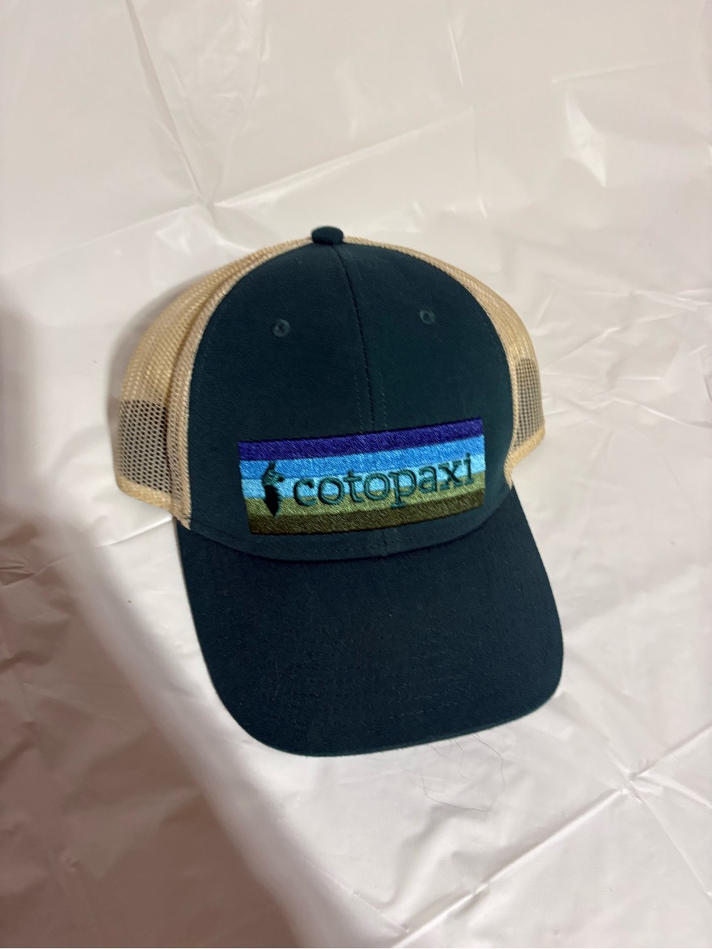 cotopaxi Dark Blue and Tan Mesh Trucker Cap with Multicolor Logo